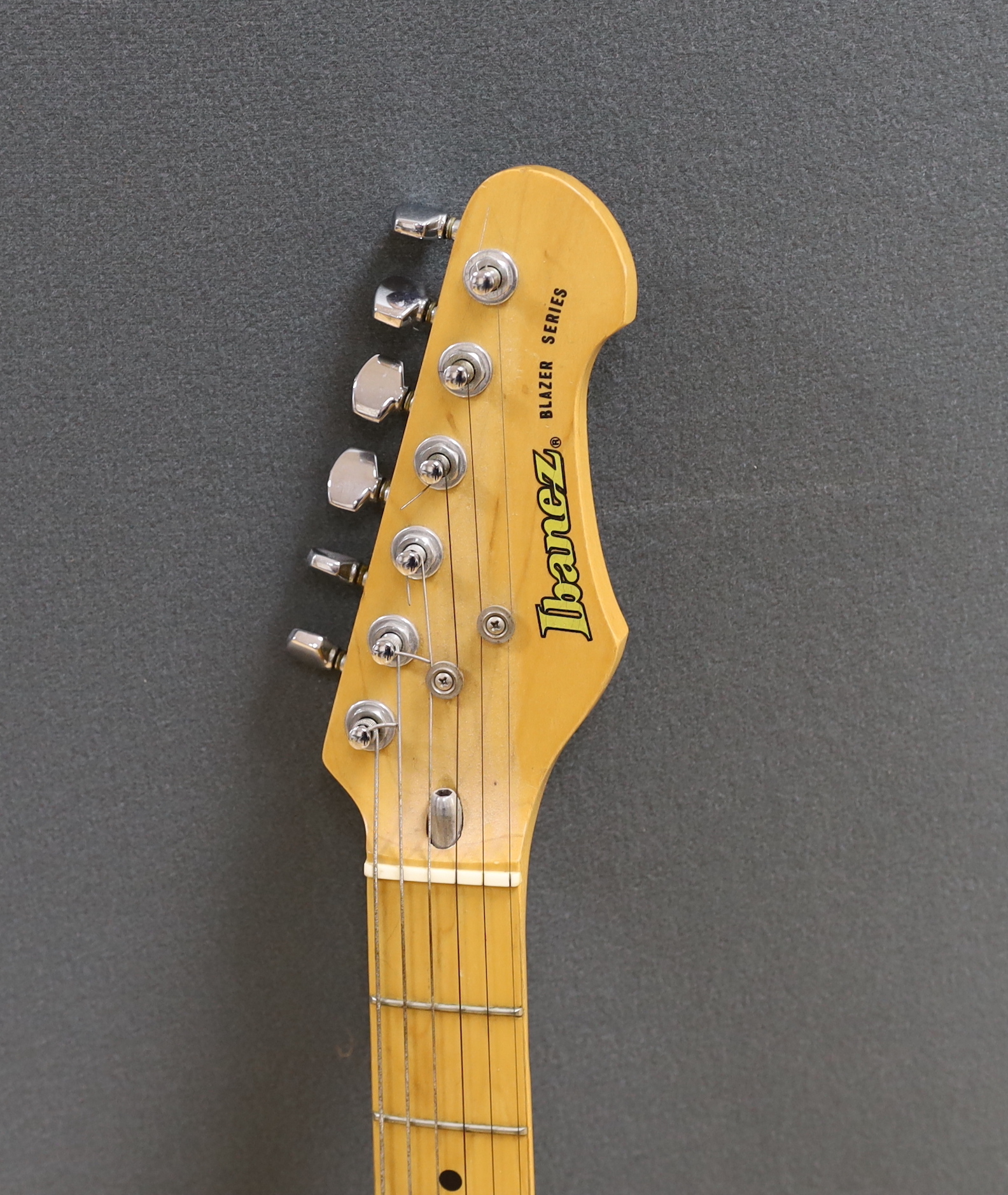 A 1980 Electric guitar by Ibanez, Japan, Blazer Series in natural finish with flight case and a small Fender Frontman 15G amp